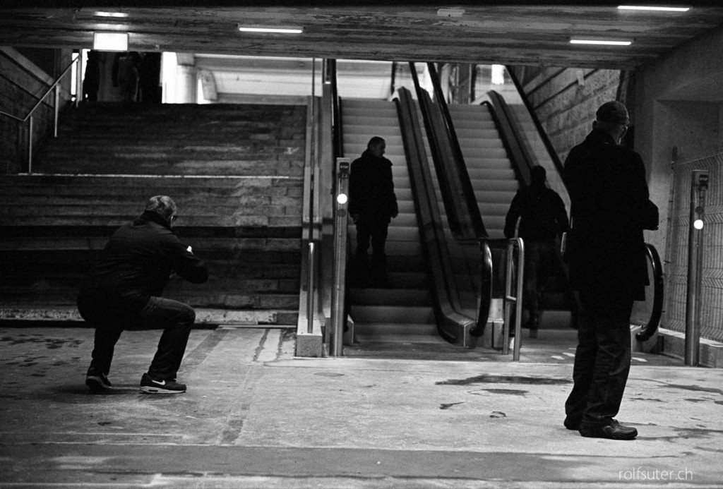 Photographer taking pictures  in the underpass at the train station in St. Gallen